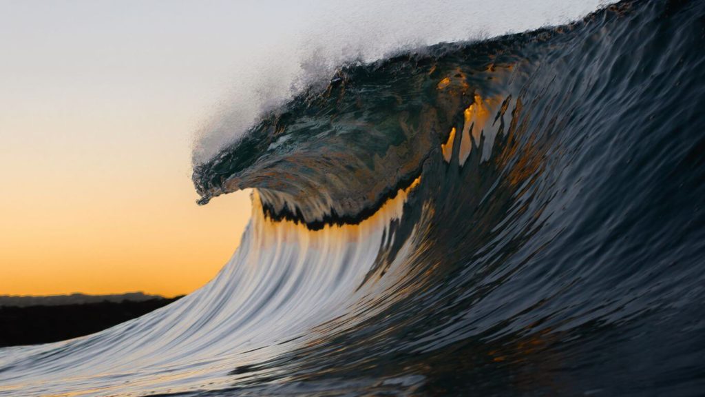 barelling wave on a sunset background